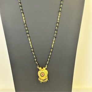 Vintage black and gold beaded necklace with pink rhinestone and tassel earrings